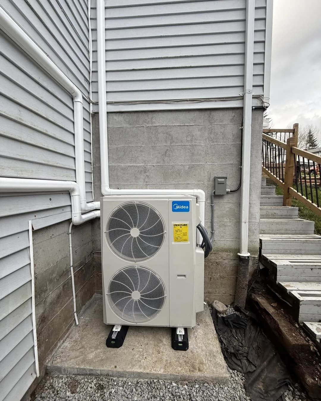 Dual-fan outdoor unit with white line-set covers